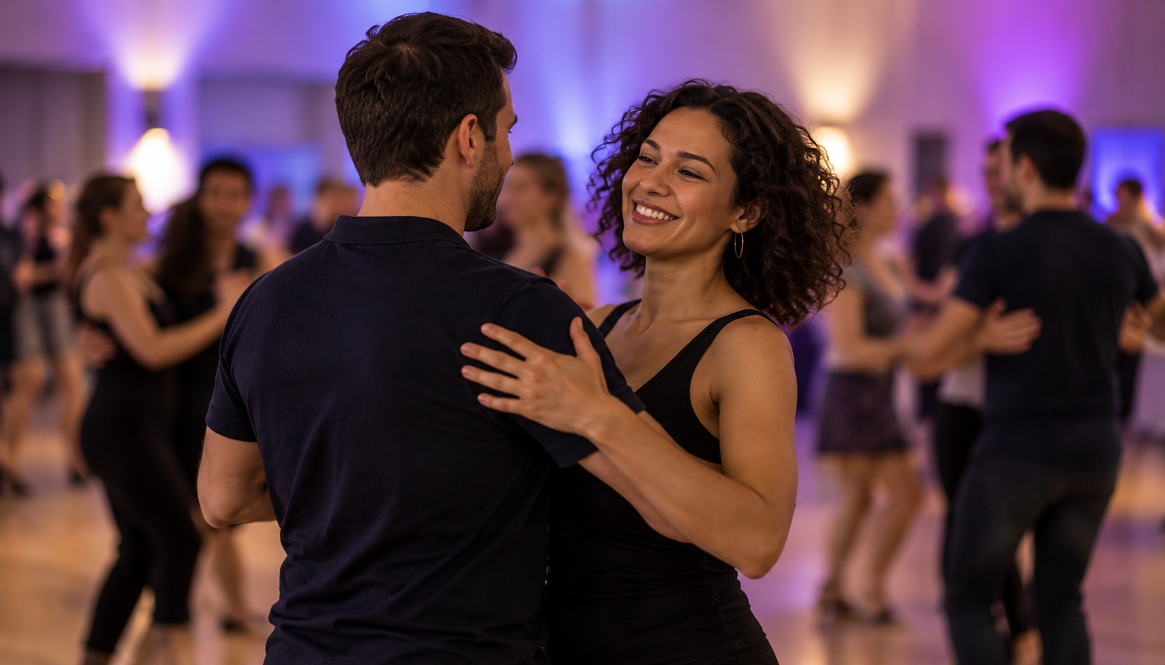 A couple enjoying a partner dance at a social event.